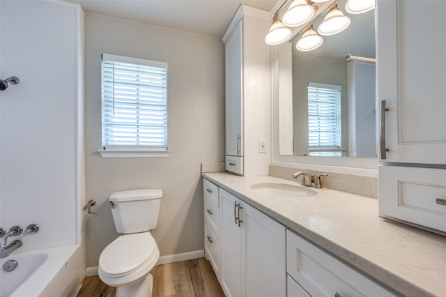 full bathroom with hardwood / wood-style floors, vanity, toilet, and plenty of natural light