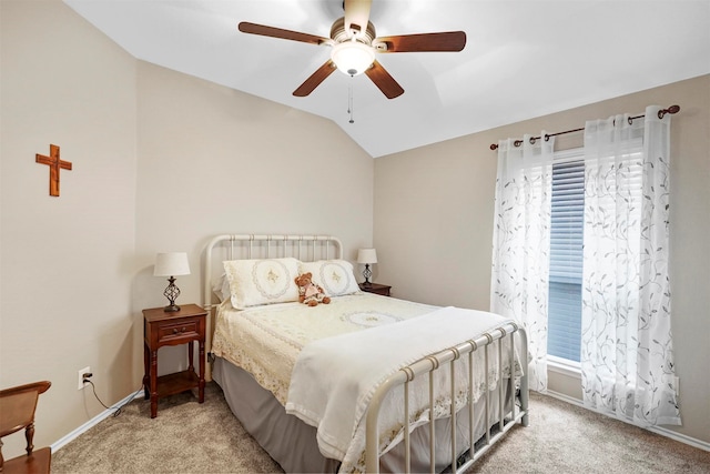 bedroom with ceiling fan, vaulted ceiling, and light colored carpet