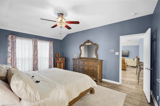 bedroom with lofted ceiling, hardwood / wood-style flooring, and ceiling fan