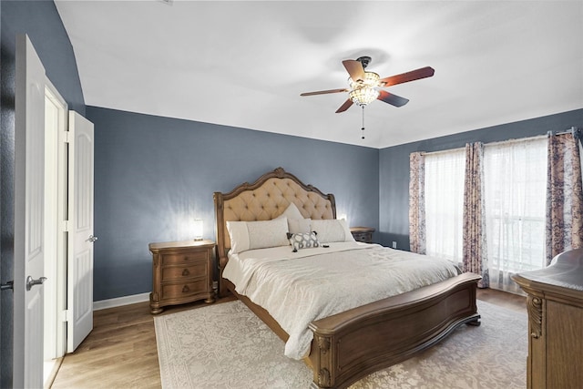 bedroom with ceiling fan and light wood-type flooring