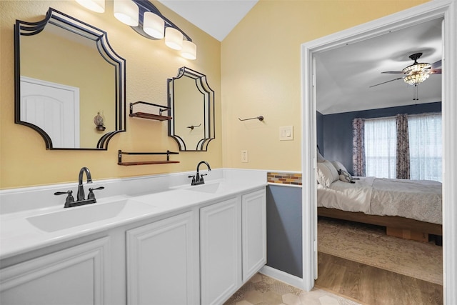 bathroom featuring ceiling fan, wood-type flooring, vanity, and lofted ceiling