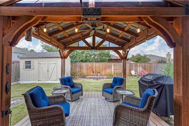 view of patio featuring a wooden deck, area for grilling, a storage unit, and a gazebo