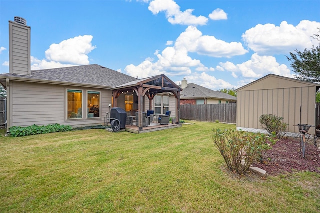 rear view of property with a lawn, a shed, and a deck