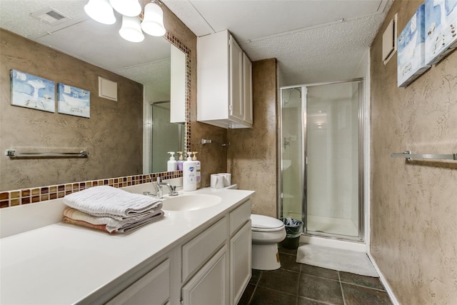 bathroom with a textured ceiling, an enclosed shower, vanity, and toilet