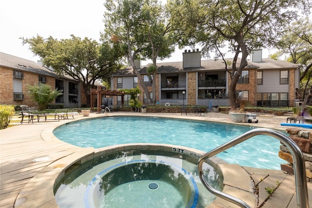 view of pool featuring a patio and a community hot tub