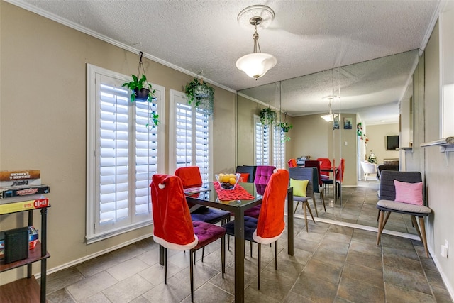 dining room with a textured ceiling, a healthy amount of sunlight, and crown molding