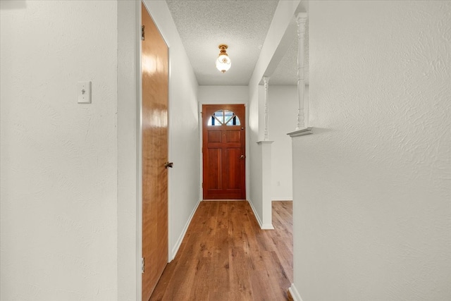 entryway featuring hardwood / wood-style flooring and a textured ceiling