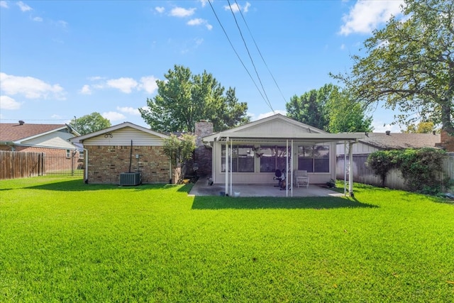 view of yard with central AC unit and a patio area