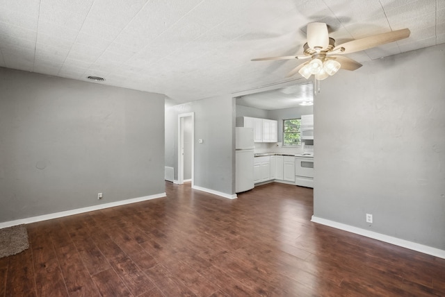 unfurnished living room with ceiling fan and dark hardwood / wood-style flooring