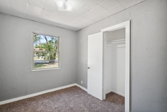 unfurnished bedroom with a closet and carpet floors