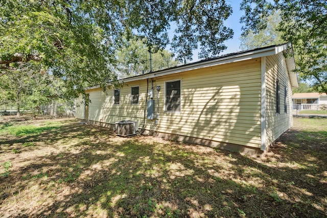 rear view of house featuring cooling unit