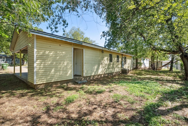 rear view of property featuring central AC