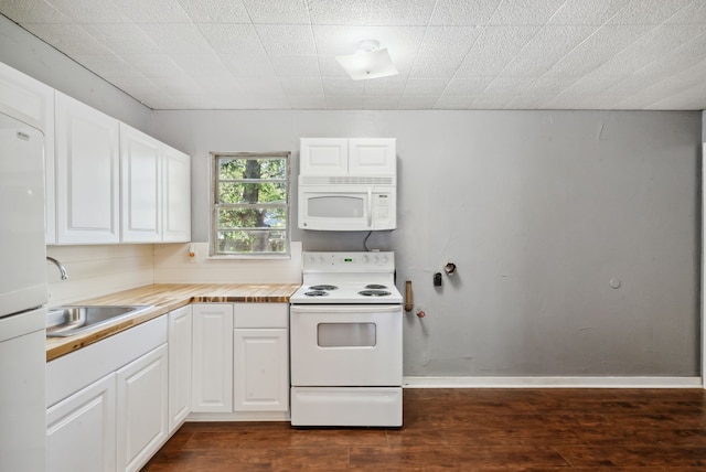 kitchen featuring sink, white appliances, white cabinetry, and dark hardwood / wood-style flooring