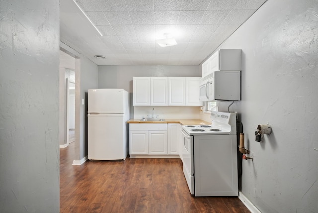 kitchen featuring white cabinets, dark hardwood / wood-style floors, sink, and white appliances