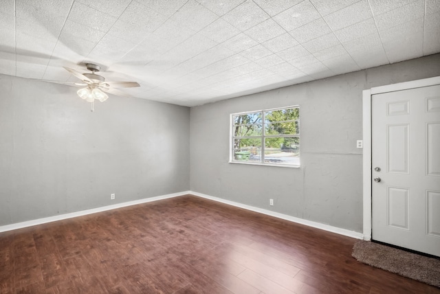 spare room featuring ceiling fan and dark hardwood / wood-style flooring