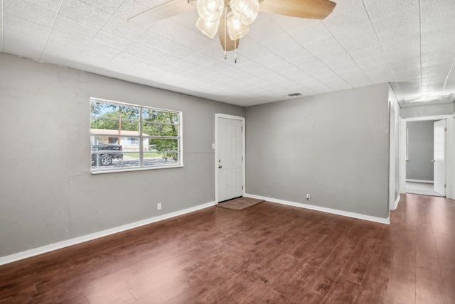 unfurnished room with ceiling fan and dark wood-type flooring