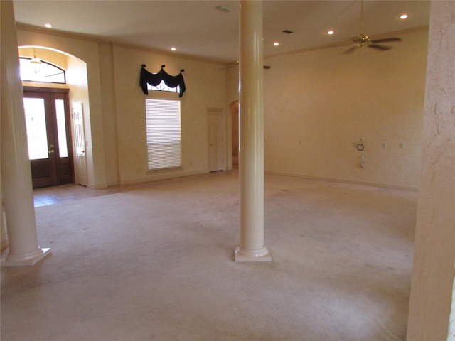 interior space with decorative columns, a healthy amount of sunlight, ceiling fan, and ornamental molding