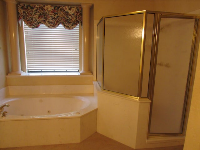 bathroom featuring separate shower and tub