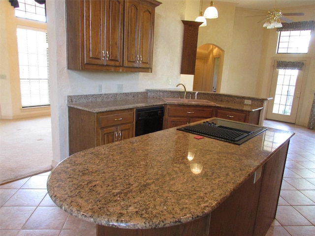 kitchen featuring sink, black dishwasher, and plenty of natural light