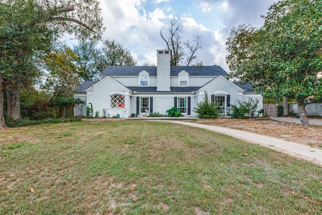 cape cod home with a front yard