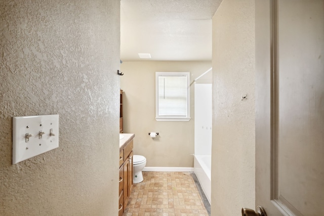 full bathroom with tub / shower combination, vanity, and toilet