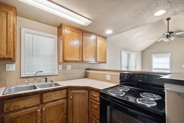 kitchen featuring black range with electric stovetop, a textured ceiling, lofted ceiling, ceiling fan, and sink