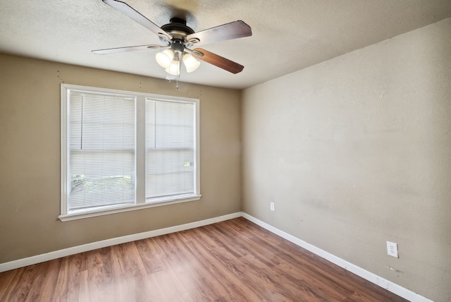 spare room with ceiling fan, hardwood / wood-style floors, and a textured ceiling