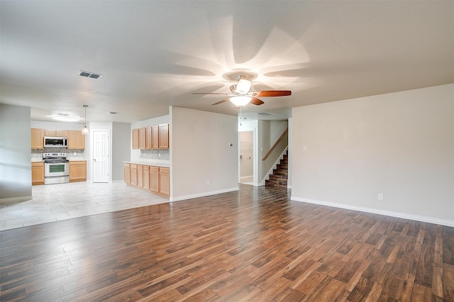 unfurnished living room with light hardwood / wood-style flooring and ceiling fan