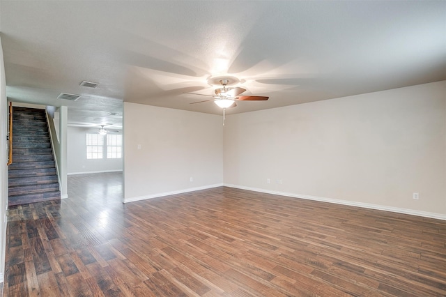 unfurnished living room with a textured ceiling, dark hardwood / wood-style floors, and ceiling fan