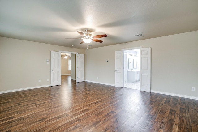 spare room with ceiling fan, a textured ceiling, and dark wood-type flooring