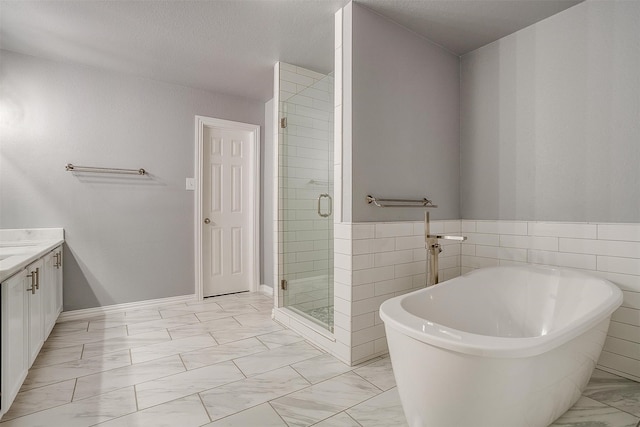 bathroom featuring vanity, tile walls, shower with separate bathtub, and a textured ceiling