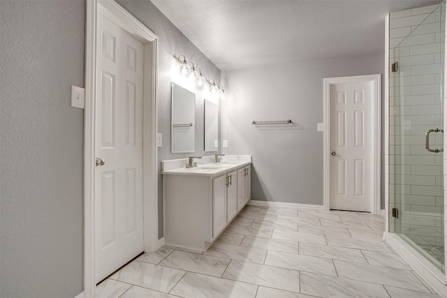 bathroom with walk in shower, a textured ceiling, and vanity