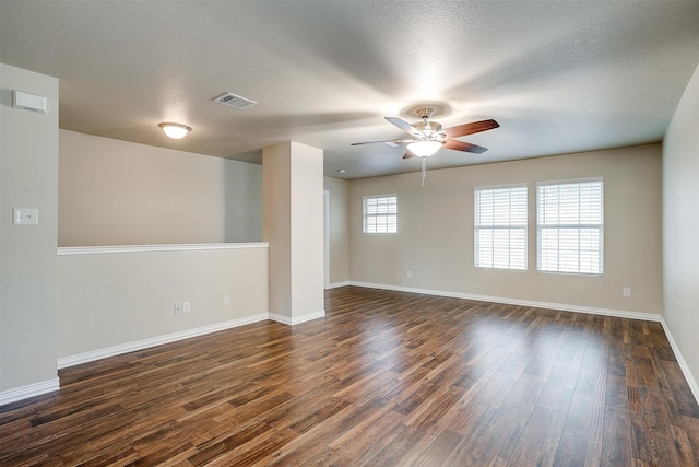 spare room featuring a textured ceiling, dark hardwood / wood-style flooring, and ceiling fan