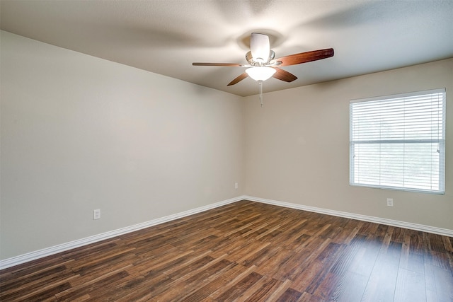 unfurnished room with dark hardwood / wood-style flooring and ceiling fan