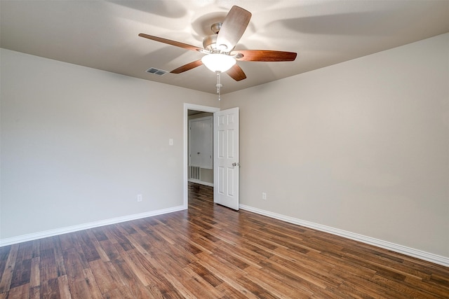 spare room featuring dark hardwood / wood-style floors and ceiling fan