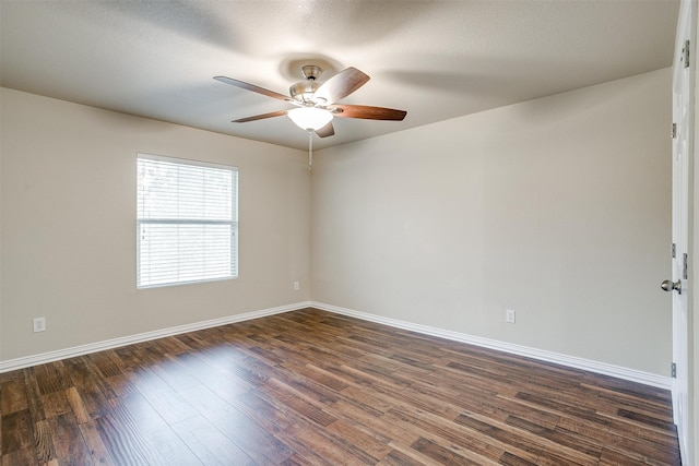 unfurnished room featuring ceiling fan, dark wood-type flooring, and a textured ceiling