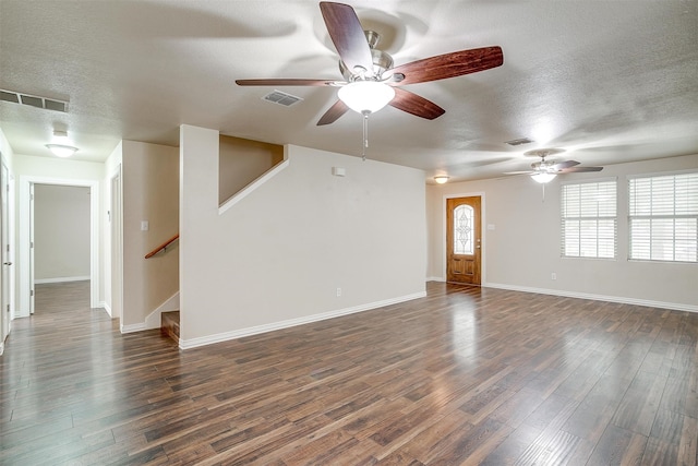 unfurnished room featuring a textured ceiling, dark hardwood / wood-style flooring, and ceiling fan