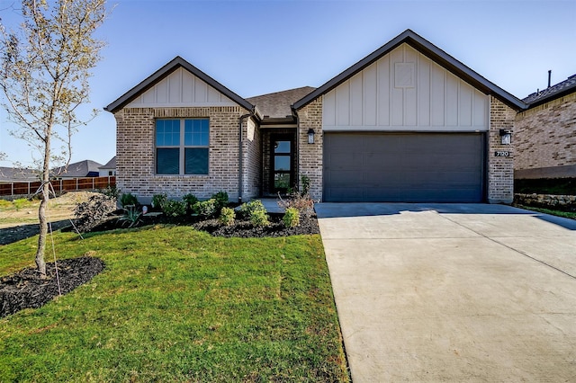 view of front of home featuring a front yard and a garage