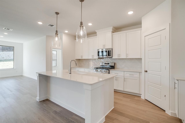 kitchen featuring light hardwood / wood-style flooring, white cabinets, stainless steel appliances, and sink