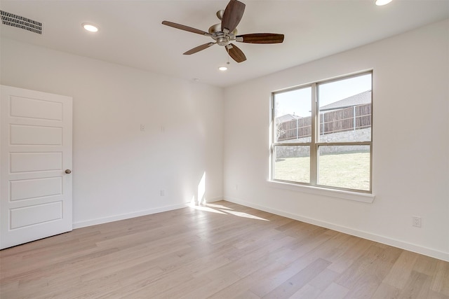 spare room featuring light hardwood / wood-style floors and ceiling fan