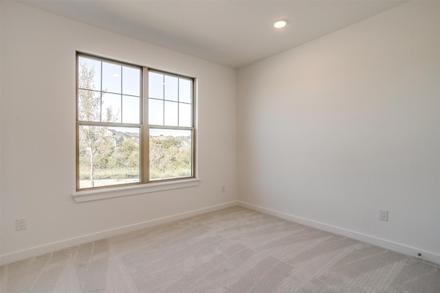 carpeted empty room with a wealth of natural light