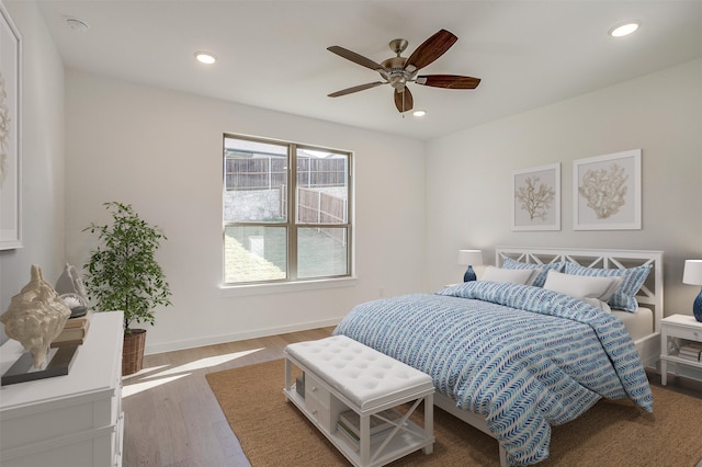 bedroom with ceiling fan and hardwood / wood-style floors