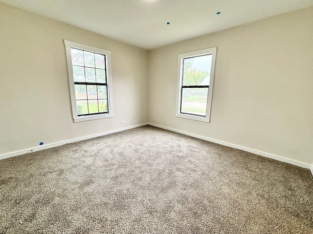 carpeted empty room with plenty of natural light