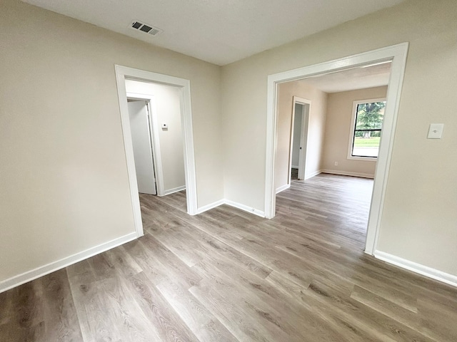 spare room featuring light hardwood / wood-style flooring