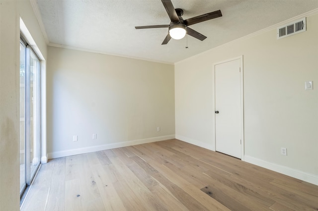 empty room with light hardwood / wood-style flooring, a textured ceiling, ceiling fan, and crown molding