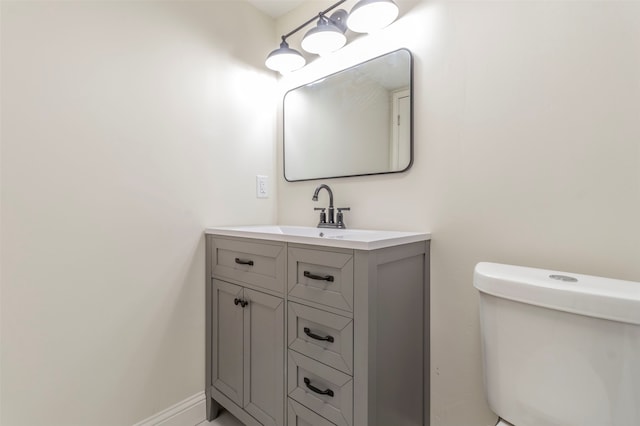 bathroom featuring toilet and vanity