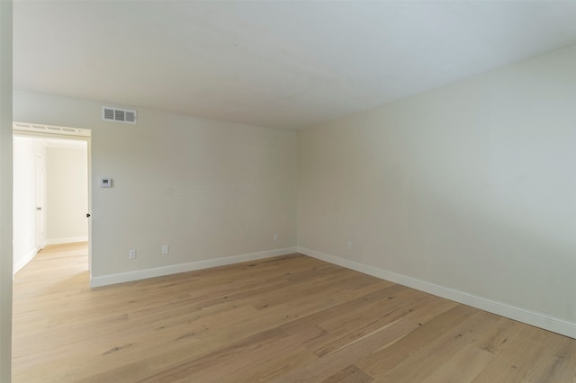 empty room with light hardwood / wood-style flooring