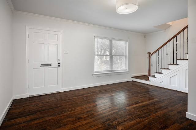 entrance foyer featuring ornamental molding and dark hardwood / wood-style flooring