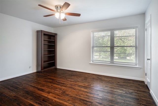 spare room featuring ceiling fan and dark wood-type flooring