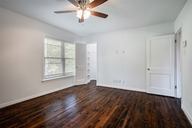 unfurnished bedroom with ceiling fan and dark wood-type flooring